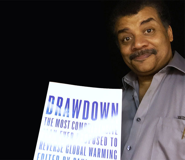 Neil deGrasse Tyson receives a copy of Drawdown.